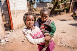Two little girls on a Zambian alley.